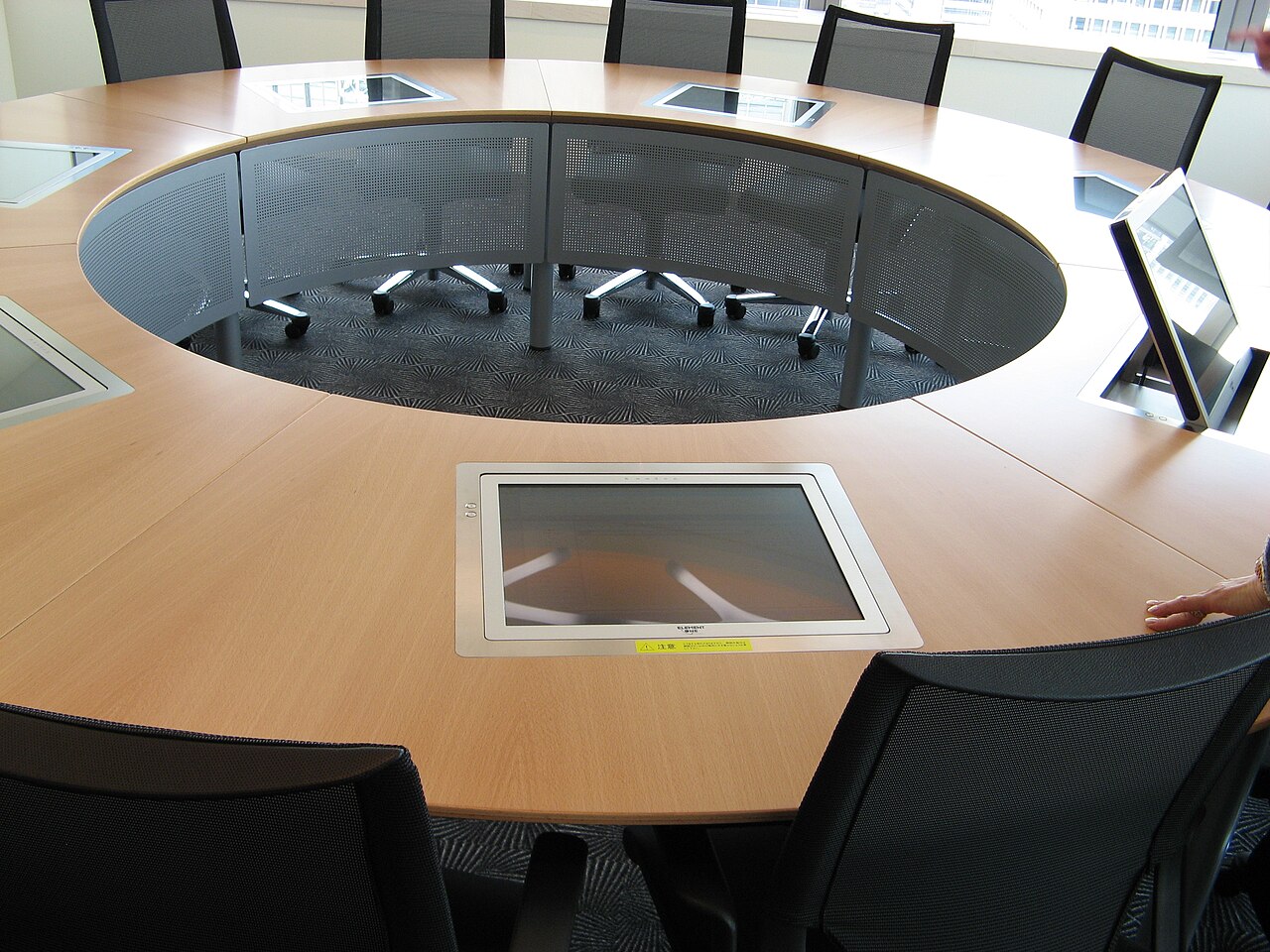 A round table in a bright office where a team works together